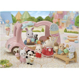 Pastel pink ice cream van for kids with 30+ colorful treats and animal ear toppings, perfect for imaginative play.