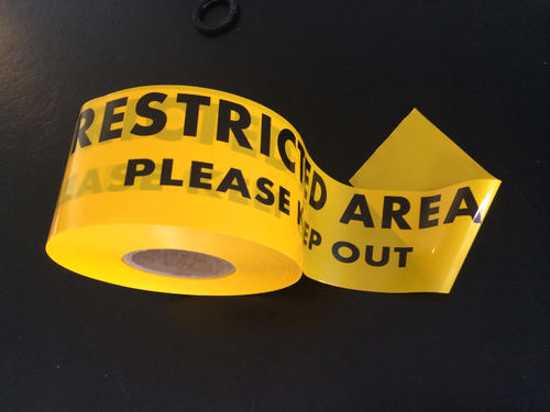Bright yellow barricade tape with black "Restricted Area Please Keep Out" text, 100mm wide and 300m long, for safety warnings.