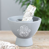 Handmade grey terracotta smudge bowl with Hamsa design, ideal for burning herbs or holding smudge sticks during rituals.
