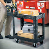 Rubbermaid heavy duty black utility cart with two lipped shelves, ergonomic handle, and 226 kg load capacity for easy transport.
