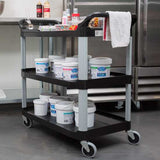 Rubbermaid 3-Tier Black Utility Cart with open sides, durable metal uprights, and 4-inch swivel casters for easy transport.