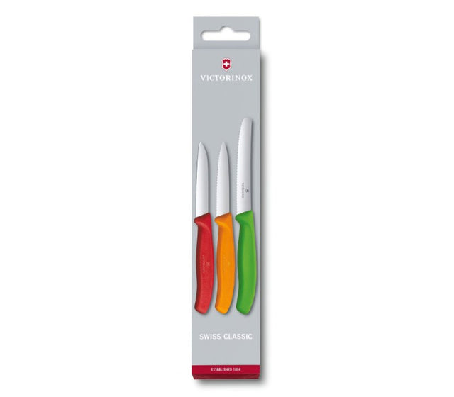 Three vibrant Victorinox paring knives including red, orange, and light green for versatile and precise kitchen cutting.