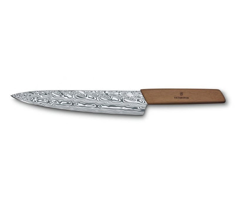 Victorinox Swiss Modern Damast Ltd Edition Carving Knife with Damasteel blade and walnut handle, showcasing artistry and elegance.