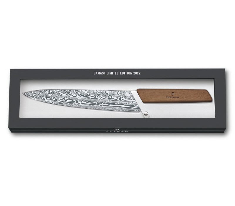 Victorinox limited edition carving knife with Damasteel blade and ergonomic walnut handle, showcasing unique 'Thor' design.