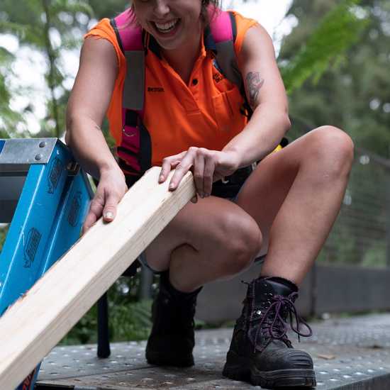 Women's black and purple zip-sided safety boot featuring water-resistant leather, steel toe cap, and slip-resistant outsole.