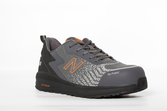 New Balance Speedware safety shoes in grey/orange, featuring composite toe cap, breathable mesh, and slip-resistant outsole.