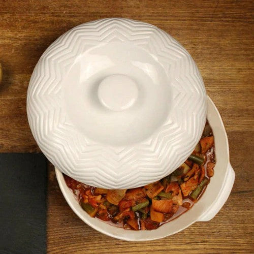 Set of two versatile lidded casserole dishes in white porcelain, perfect for cooking, serving, and storing meals.