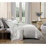 Opulent Platinum Seville Metallic Jacquard Quilt Set in Snow, featuring a king size quilt and two pillowcases with a luxe sheen.