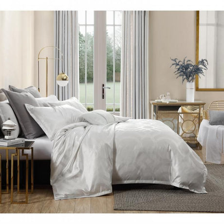 Opulent Platinum Seville Metallic Jacquard Quilt Set in Snow, featuring a king size quilt and two pillowcases with a luxe sheen.