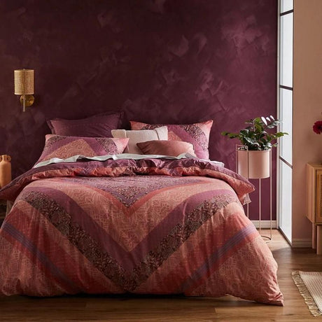 Bohemian-style quilt set featuring an oversized diamond pattern in berry tones, perfect for super king beds.