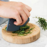 Half-moon herb cutter set for effortless chopping and mincing of fresh herbs with a concave bowl for easy collection.