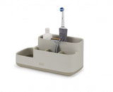 Stylish ecru bathroom caddy with divided compartments for organized storage of grooming essentials and a non-slip base.