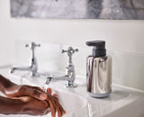 Sleek stainless steel soap pump with easy-push head, 300 ml capacity, and non-slip base for modern kitchens or baths.