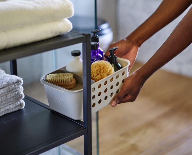 Joseph Joseph EasyStore Bathroom Storage Basket with ventilated sides and moveable tray for organized grooming essentials.