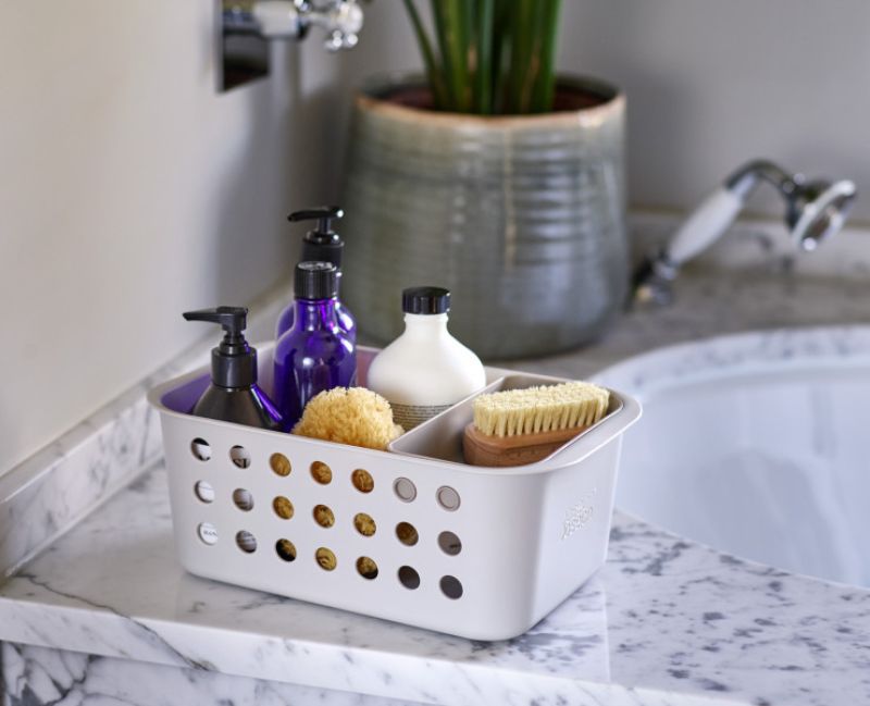 Joseph Joseph EasyStore Bathroom Storage Basket for organizing grooming essentials, featuring ventilated sides and a moveable tray.