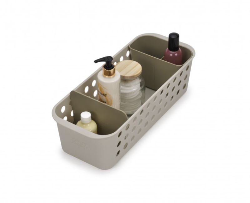 Compact bathroom storage basket with ventilated sides, moveable pot, and divider for organizing grooming essentials.