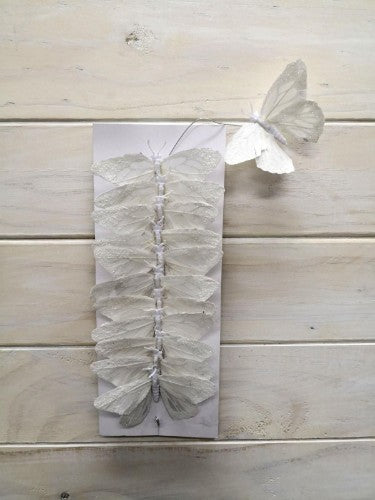 Set of 12 white artificial butterflies with glitter, 9cm, featuring feather bodies and bendable wire for crafts and decor.