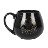 Black mug with a color-changing feature revealing a crystal ball fortune when hot liquid is added, holds 500ml.