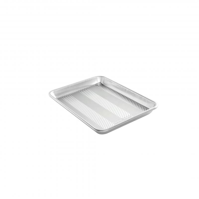 Nordic Ware Prism Quarter Sheet Pan with embossed design for even baking, durable construction, and a stylish look for home bakers.