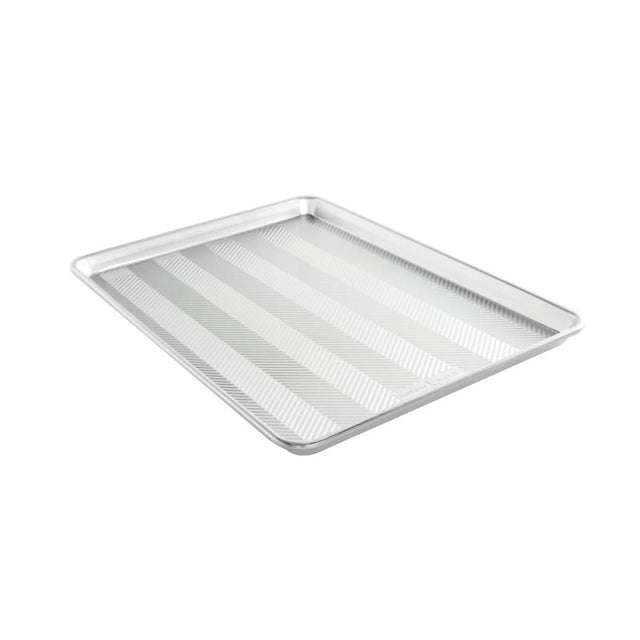 Nordic Ware Prism Big Sheet: oversized aluminum baking sheet with embossed design for even heating and durability.