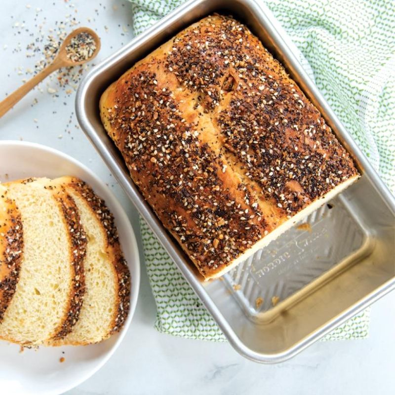 Aluminum loaf pan with Prism grid design for even baking and easy release, perfect for bread and versatile recipes.