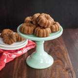 Nordic Ware Mini Bundt® Cupcake Pan in radiant red, bakes 12 personal-sized Bundt® cakes with high-quality aluminum for even results.