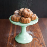 Nordic Ware Mini Bundt® Cupcake Pan in red, bakes 12 personal-sized Bundt® cakes with even heat distribution.