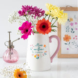 Ceramic flower jug with pink handle, featuring 'If Mums were flowers, I'd pick you' and vibrant floral accents.