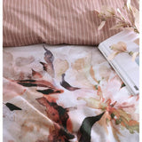 King size Tessa Printed Quilt/Duvet Set in peach, featuring floral blooms and striped backing with white cord piping.