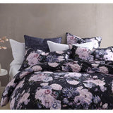 Luxurious violet velvet pillowcase featuring winter blooms, foliage pattern reverse, and black piping for elegant bedding.