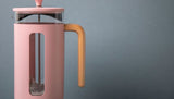 Stylish La Cafetiere Pink Pisa 8 Cup Cafetiere, featuring heat-resistant glass and a beechwood handle for perfect brews.