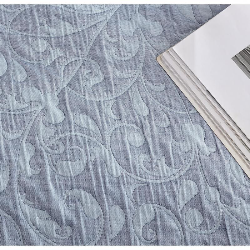 Elegant blue jacquard quilt and pillowcase set for Queen bed, showcasing a floral pattern and soft, durable fabric blend.