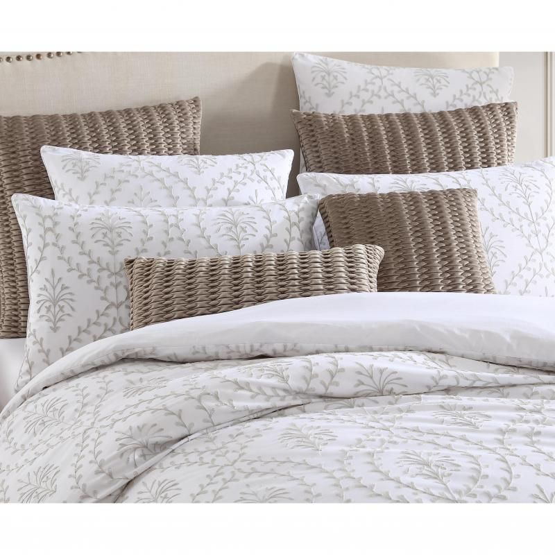 Elegant latte pillowcase featuring delicate embroidery and white cord piping, perfect for enhancing bedroom decor.