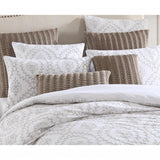 Elegant latte pillowcase featuring delicate embroidery and white cord piping, perfect for enhancing bedroom decor.