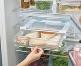 Under-shelf storage drawer designed to maximize fridge space, featuring easy-pull handle and secure suction cups for organization.