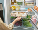 Under-shelf storage drawer for fridges, maximizing space with easy-pull handle and secure suction cup design.