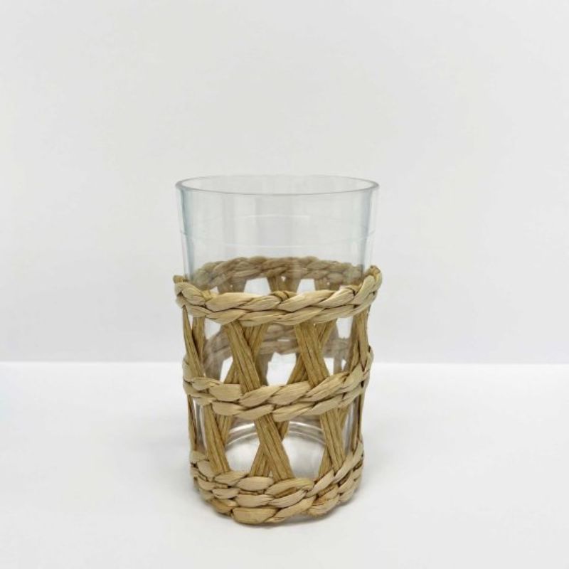 Clear plastic tumbler with a natural seagrass sleeve, perfect for eco-friendly drinkware on-the-go.