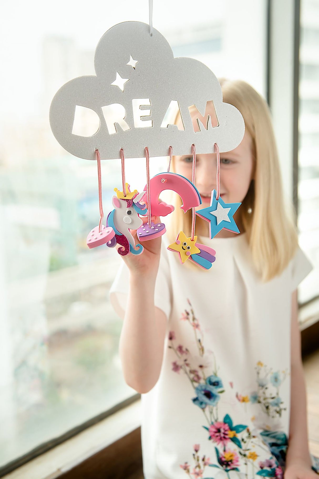 Colorful 6-in-1 DIY Craft Box for kids, featuring dream catchers, unicorn masks, charms, hairbands, wands, and no-bake cheesecakes.