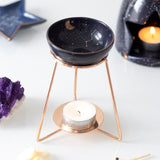 Purple star sign oil burner on gold metal base, featuring a celestial dish accentuated with gold details, perfect for relaxation.