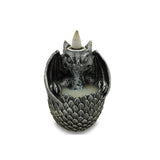 Intricate black backflow incense burner shaped like a dragon with glowing crystals creating a mesmerizing smoke waterfall effect.