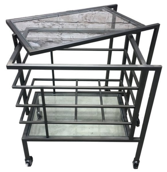 Elegant cocktail trolley featuring clear glass shelves and a stainless steel frame, perfect for entertaining and serving drinks.