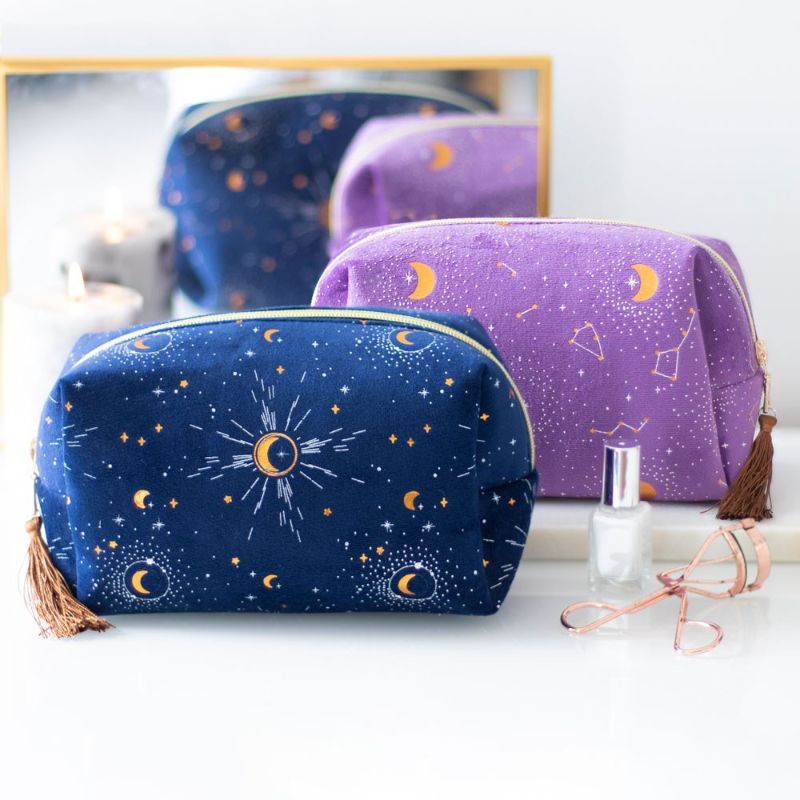 Purple velvet makeup bag with gold crescent moon accents and tassel, perfect for organizing beauty essentials stylishly.