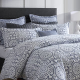 Queen Duvet Cover Set in Mayfair Navy featuring quilted design and folk art motifs on a crisp white background for modern elegance.