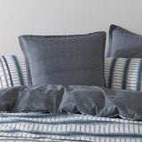 Elegant Mason Indigo European pillowcase featuring geometric patterns in indigo and grey, perfect for a modern bedroom decor.