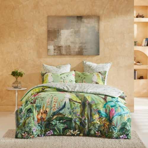 Queen duvet cover set in Aviary Green features tropical flora on a soft watercolor backdrop, perfect for a serene bedroom makeover.