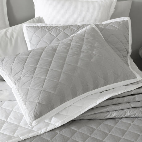 Quilted Essex Pewter pillowcase sham pair with crisp white edges, providing comfort and elegance for any bedroom decor.