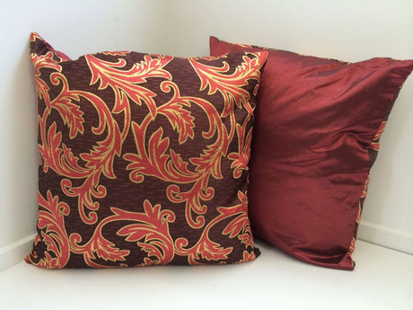 Set of 2 maroon cushion covers with vine design and satin finish, perfect for enhancing home decor and comfort.