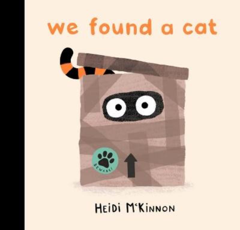 Hardcover picture book "We Found a Cat" featuring whimsical illustrations of a cat with whiskers and a long tail.
