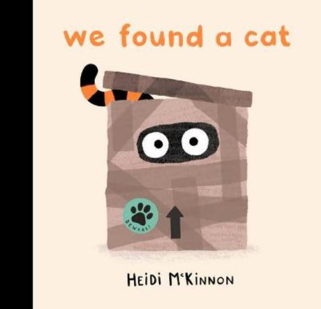 Hardcover picture book "We Found a Cat" featuring whimsical illustrations of a cat with whiskers and a long tail.