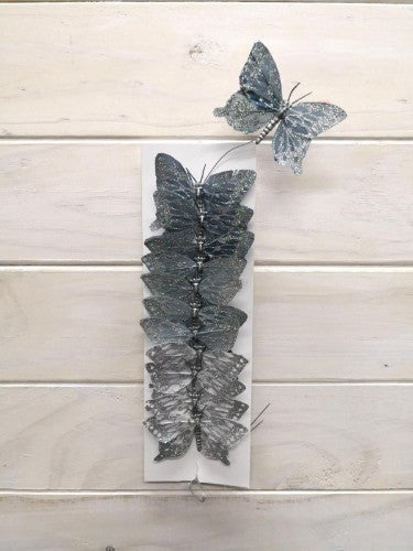 Set of 12 shimmering silver glitter artificial butterflies, made from feathers, perfect for festive and creative decor.